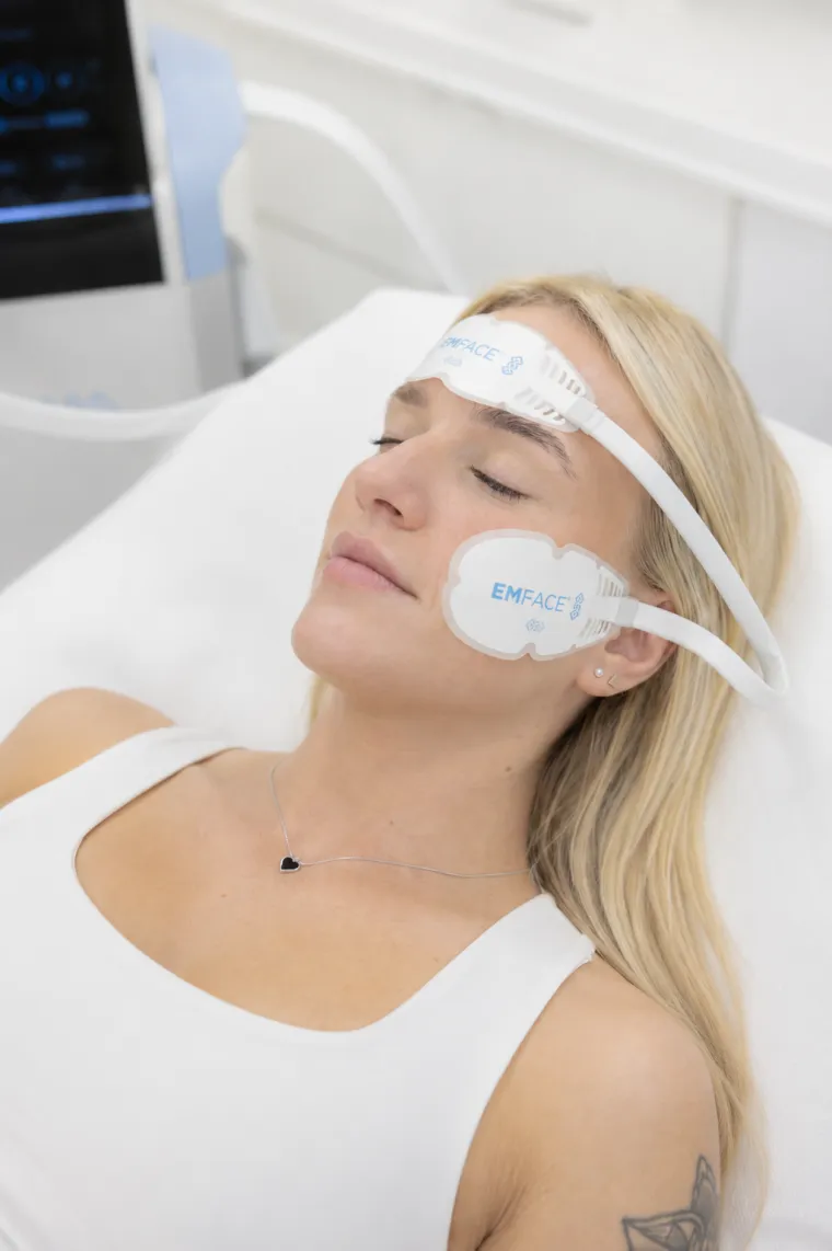 EMFACE treatment in progress — applicators on the forehead and cheek at Feonix Aesthetics, Coventry.